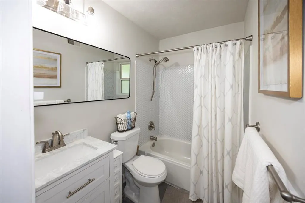 Bathroom featuring shower / tub combo and vanity