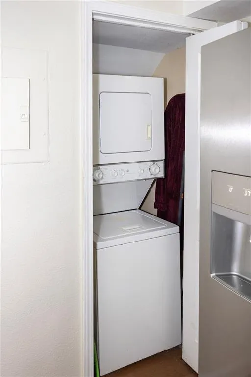 Laundry area featuring stacked washer / drying machine
