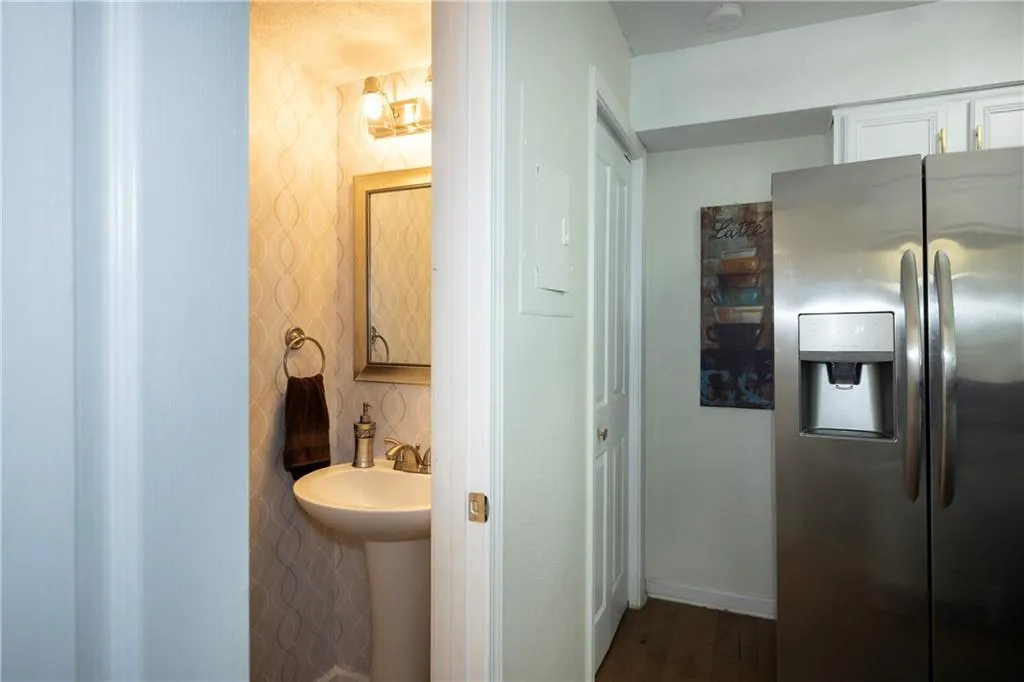 Bathroom with wood finished floors and baseboards
