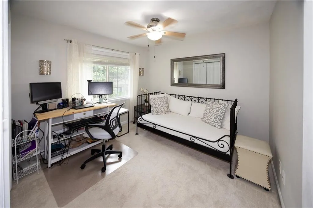 Carpeted office space with ceiling fan/Bedroom 2