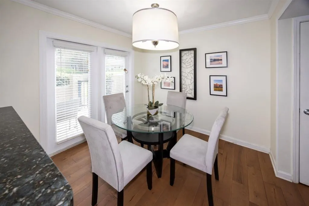 Dining space featuring crown molding and wood finished floors