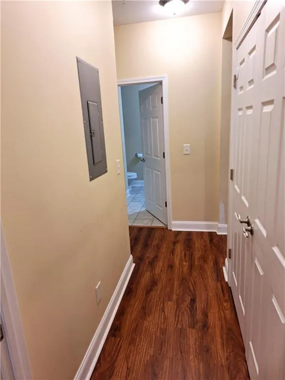 View from Secondary Bedroom door. Laundry Closet to the right and full bath straight ahead.