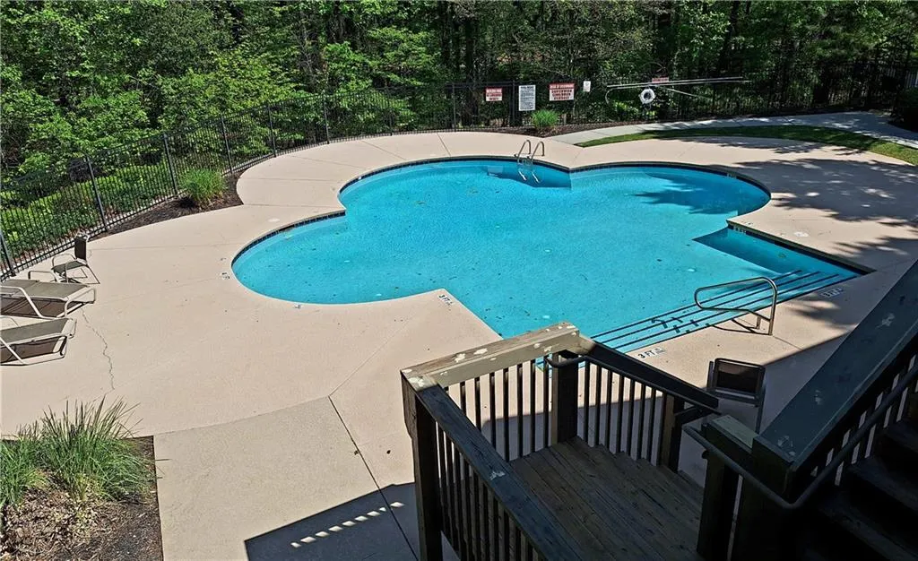 Resort-style community pool. Pool is pleasantly buffered and surrounded by trees and greenery. (Note: HOA-provided poolside lounge chairs will be in place after May 1st!)