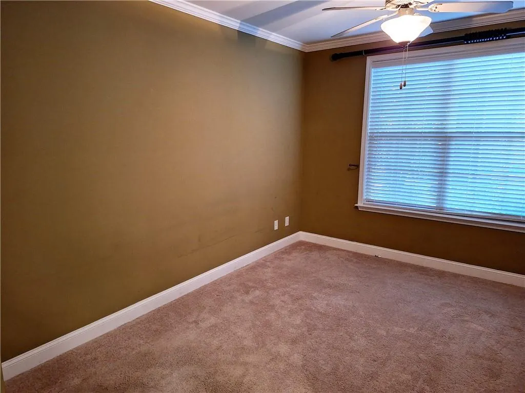 Primary Bedroom with carpet and ceiling fan