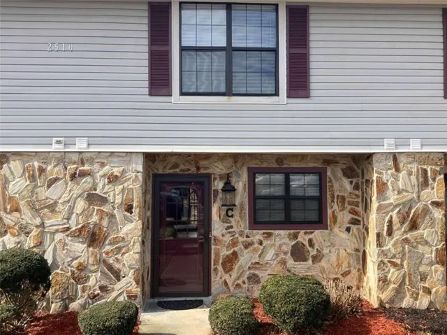 Exterior featuring stone veneer and light gray horizontal siding