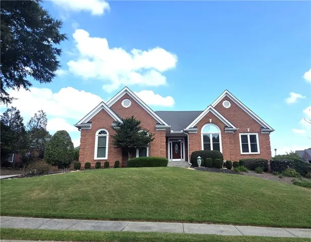 Brick exterior with gabled roof lines and white trim accents