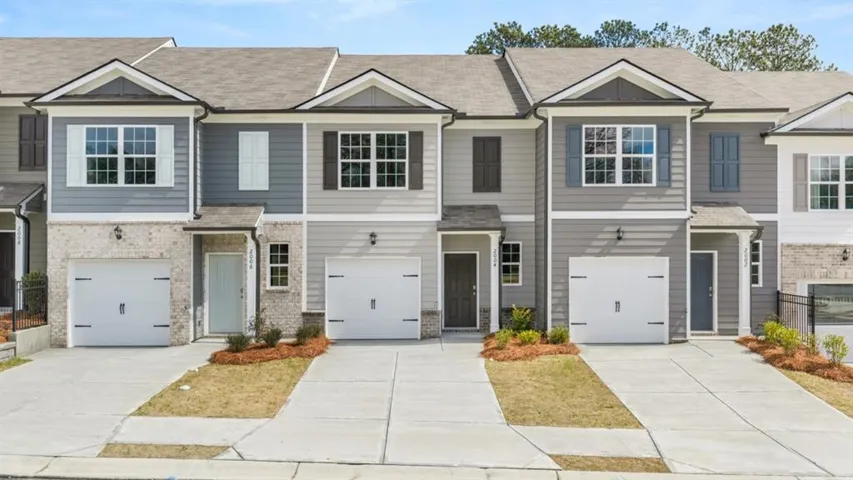 Craftsman house with a shingled roof, concrete driveway, an attached garage, and brick siding
