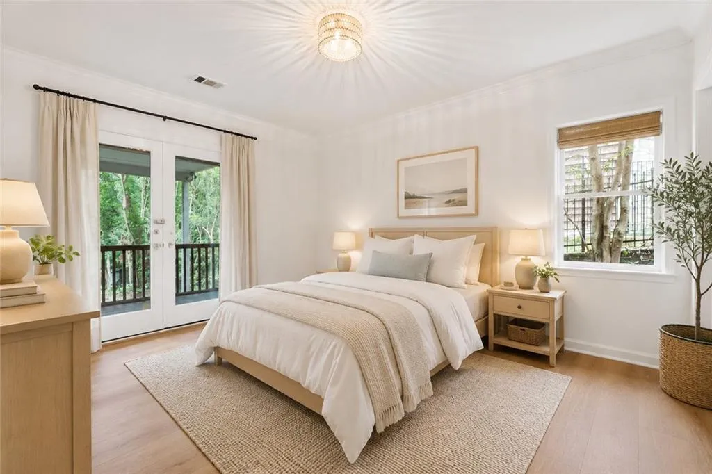 Lower Level Bedroom - Wood-finish flooring, crown molding, and a decorative ceiling light fixture  ** VIRTUALLY STAGED **