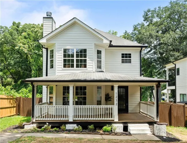 Siding exterior with multiple windows, an inviting front porch, and a dedicated entry door