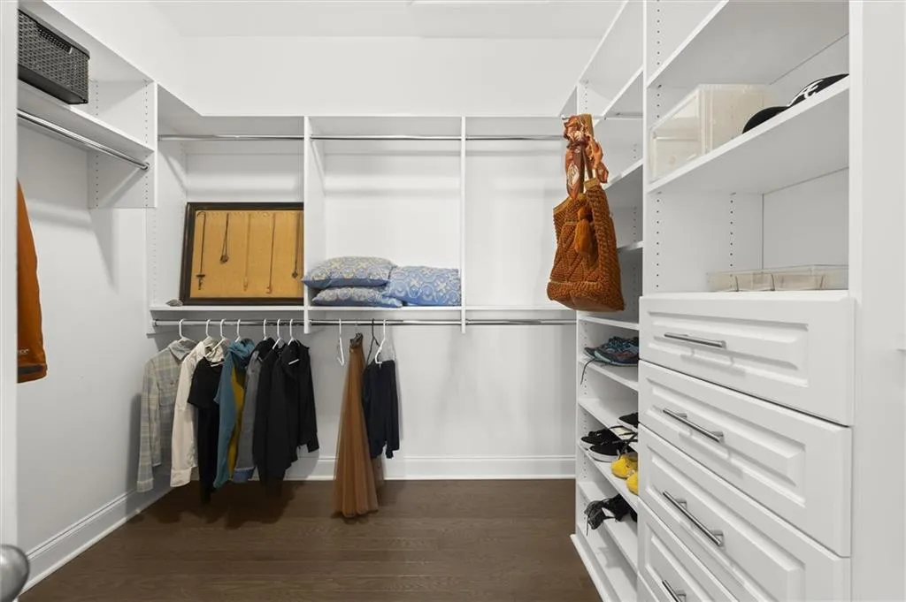 Spacious closet with dark wood-style flooring
