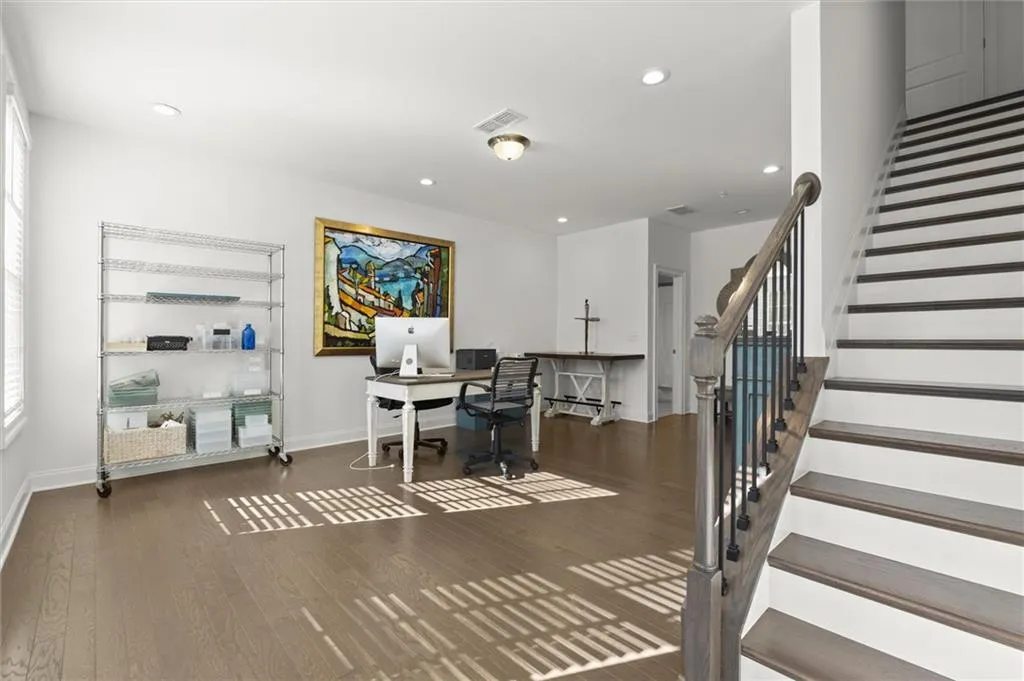 Office featuring dark wood-type flooring and recessed lighting