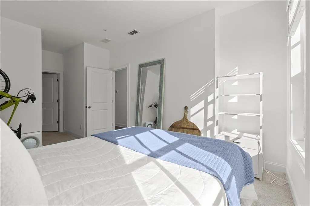 Bedroom featuring light colored carpet and baseboards