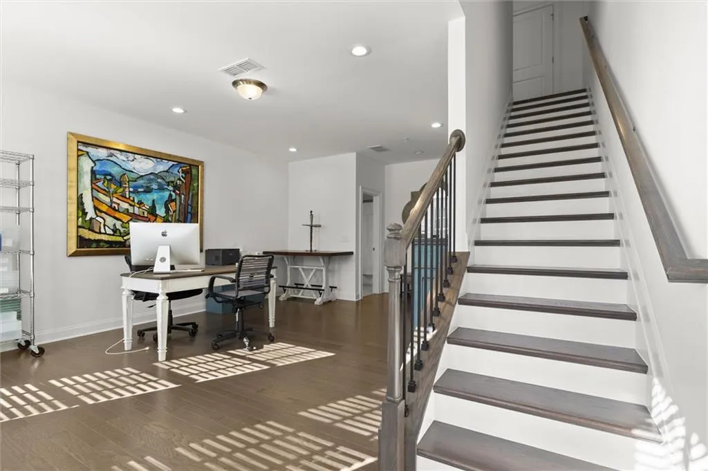 Office area with dark wood-type flooring and recessed lighting