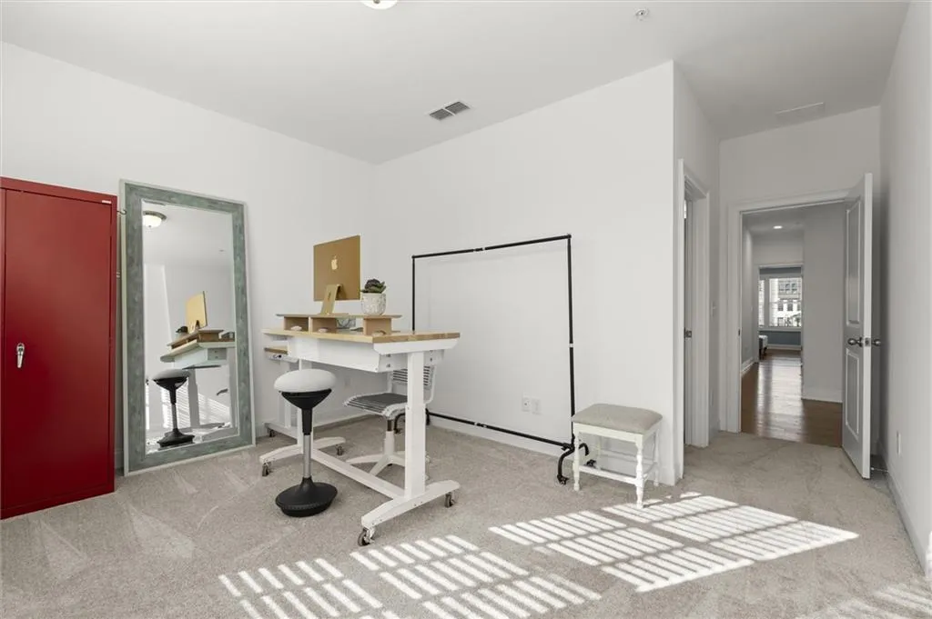 Office featuring light colored carpet