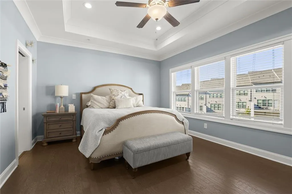 Primary Bedroom with dark wood finished floors, recessed lighting, crown molding, and ceiling fan