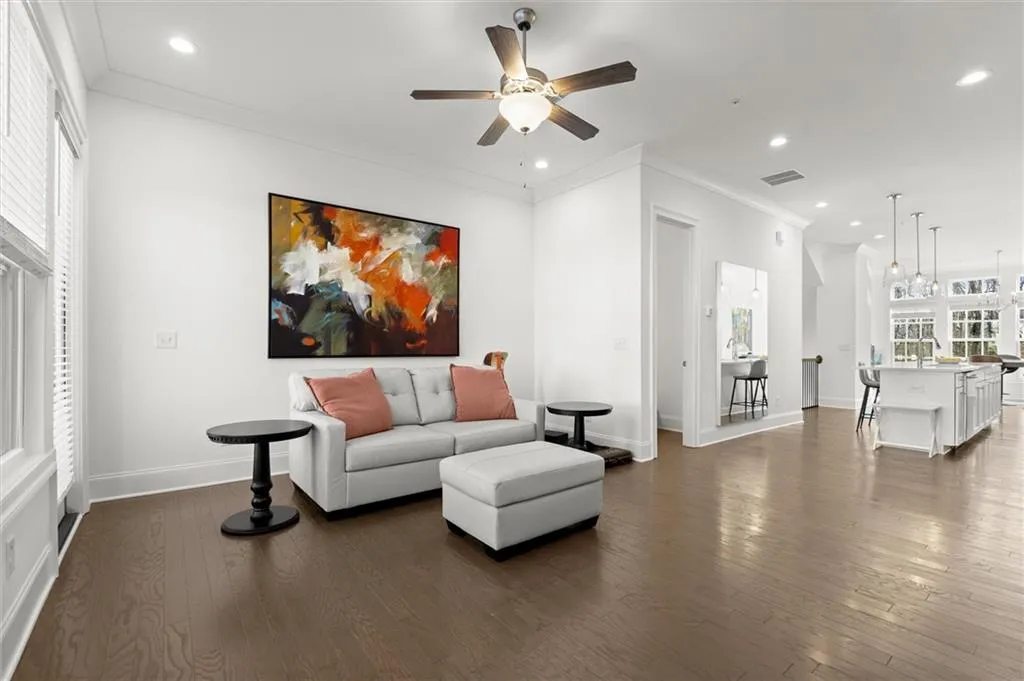 Family room featuring ornamental molding, dark wood-style floors, recessed lighting, and ceiling fan