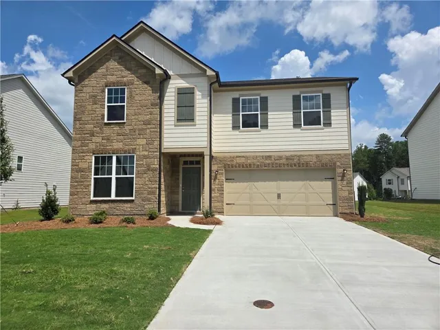 Two-story residence featuring a stone and siding facade