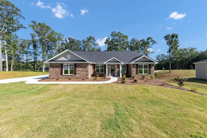 Brick exterior with gabled roofline, dark shingle roof, and white trim accents