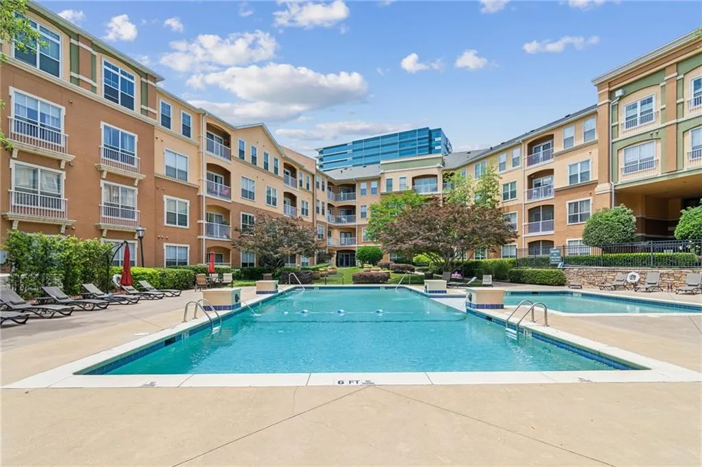 Community pool featuring a patio