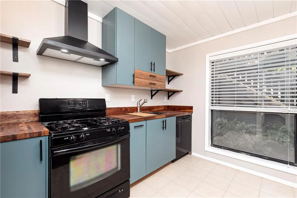 Kitchen featuring black appliances, butcher block counters
