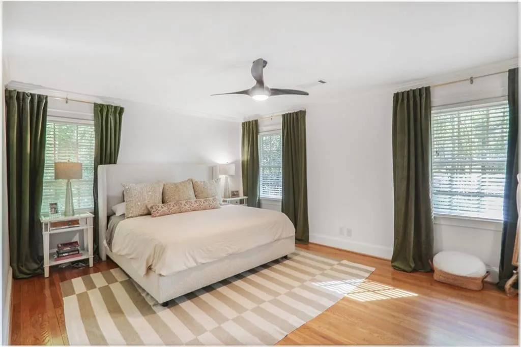 Bedroom with vbaseboards, ceiling fan, and wood finished floors