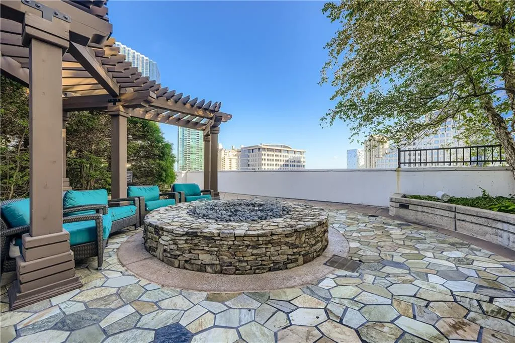 View of patio / terrace featuring a pergola and an outdoor living space with a fire pit