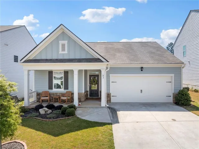 Covered front porch with white columns and stone accents