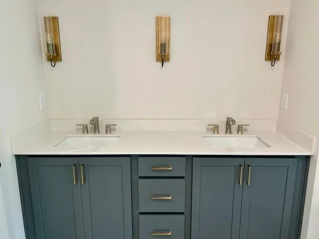 Large double vanity with brass sconces