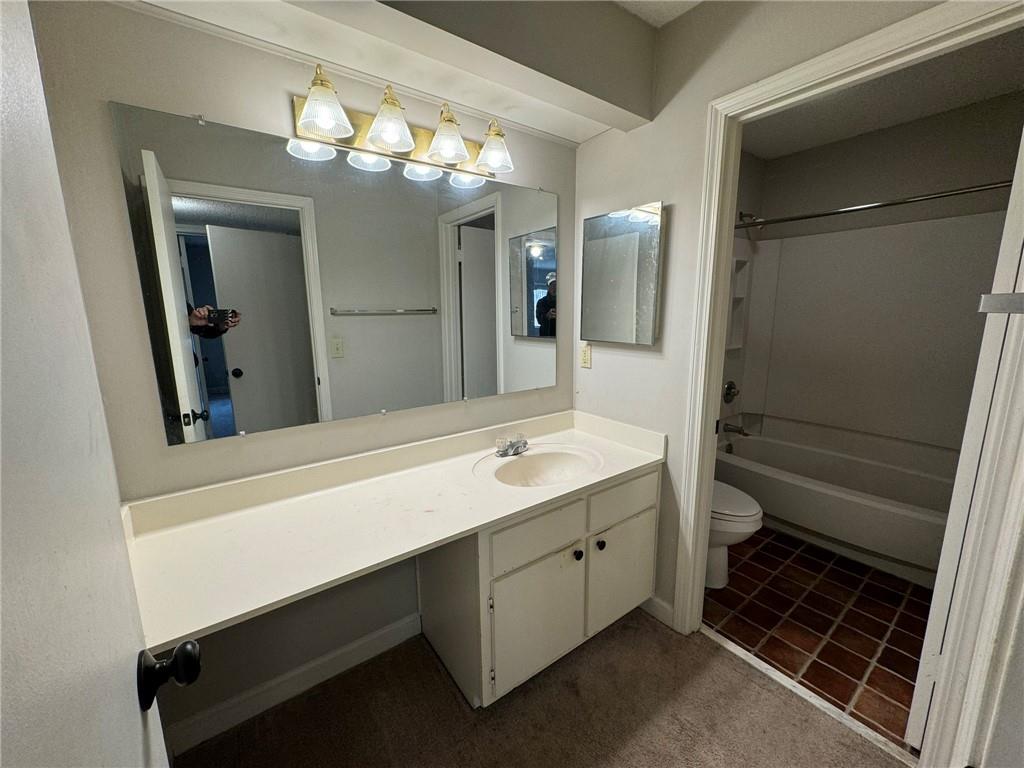 Full bathroom with toilet, vanity, shower / bath combination, and tile flooring