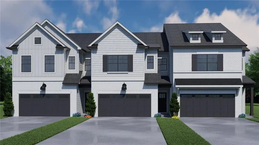 Modern townhouse exterior featuring a combination of light brick and vertical siding, dark framed windows with shutters, and attached two-car garages
