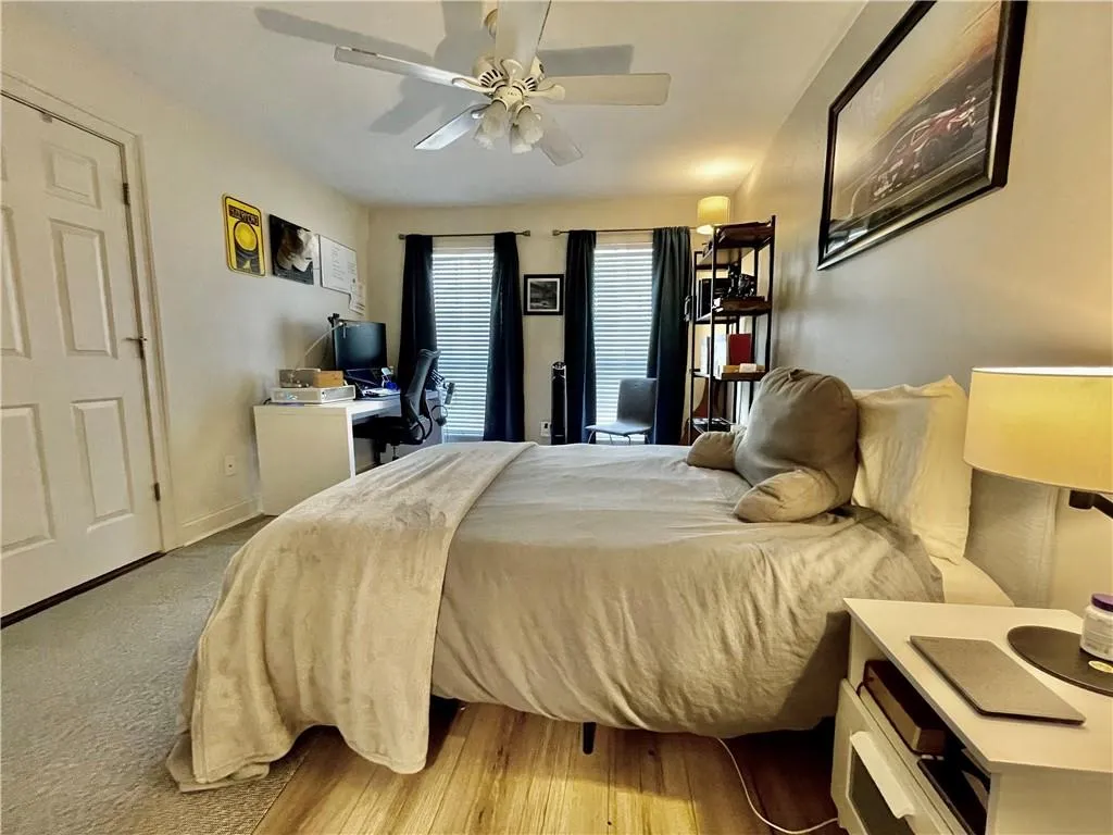Bedroom featuring ceiling fan and light carpet