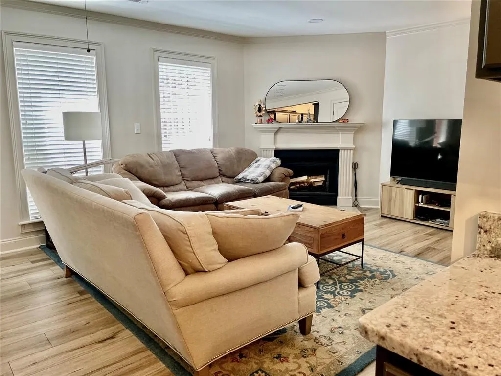 Living room featuring crown molding and light hardwood / wood-style flooring