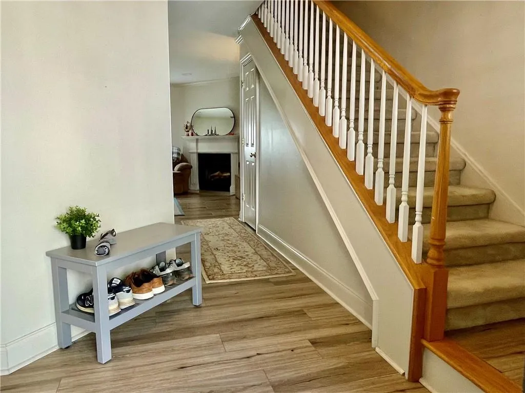 Staircase with light hardwood / wood-style flooring
