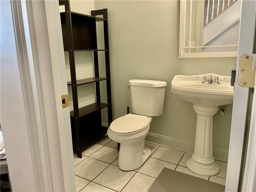 Bathroom with toilet and tile floors