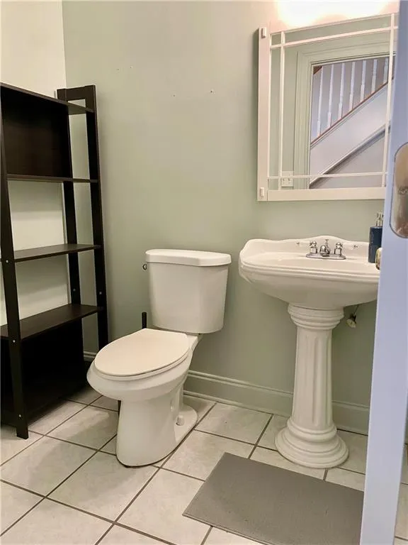 Bathroom featuring tile flooring and toilet