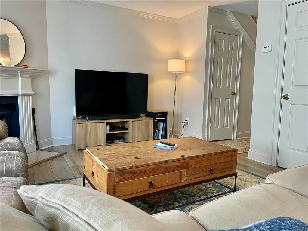 Living room featuring light hardwood / wood-style floors and ornamental molding