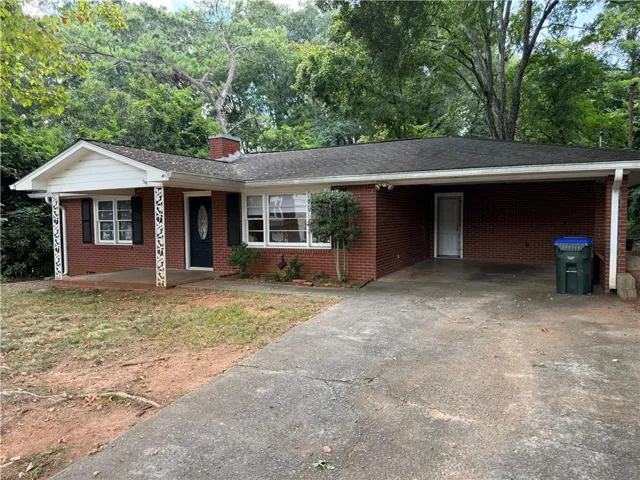 Brick exterior with a covered front porch featuring decorative columns