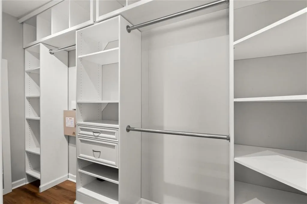 Walk in closet with two entrances.