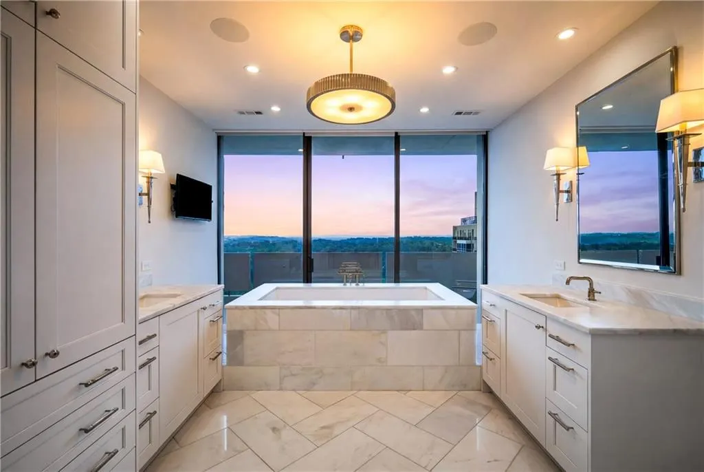 Bathroom with vanity, a garden tub, and recessed lighting