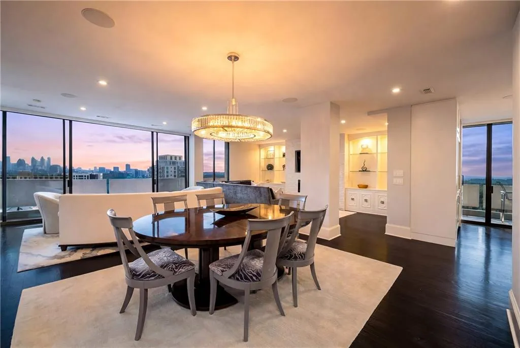 Dining room with expansive windows, a view of skyline, dark wood-type flooring, and suspended lighting
