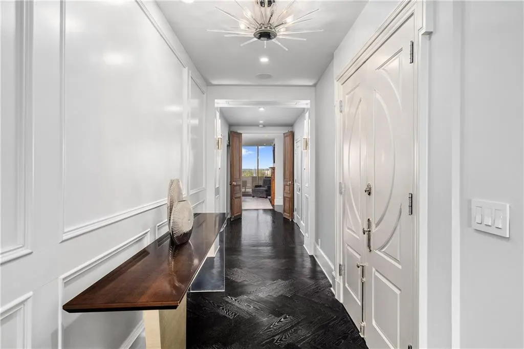 Hallway with parquet floors and recessed lighting