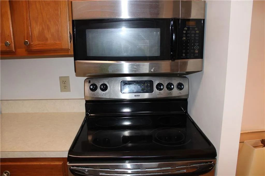 Kitchen view of stainless steel appliances, light countertops, and brown cabinets Kitchen view of stainless steel appliances, light countertops, and brown cabinets