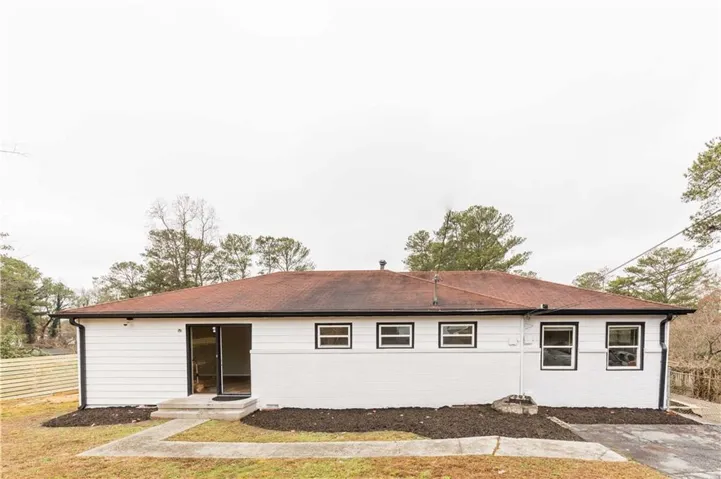 White siding exterior with a red shingle roof