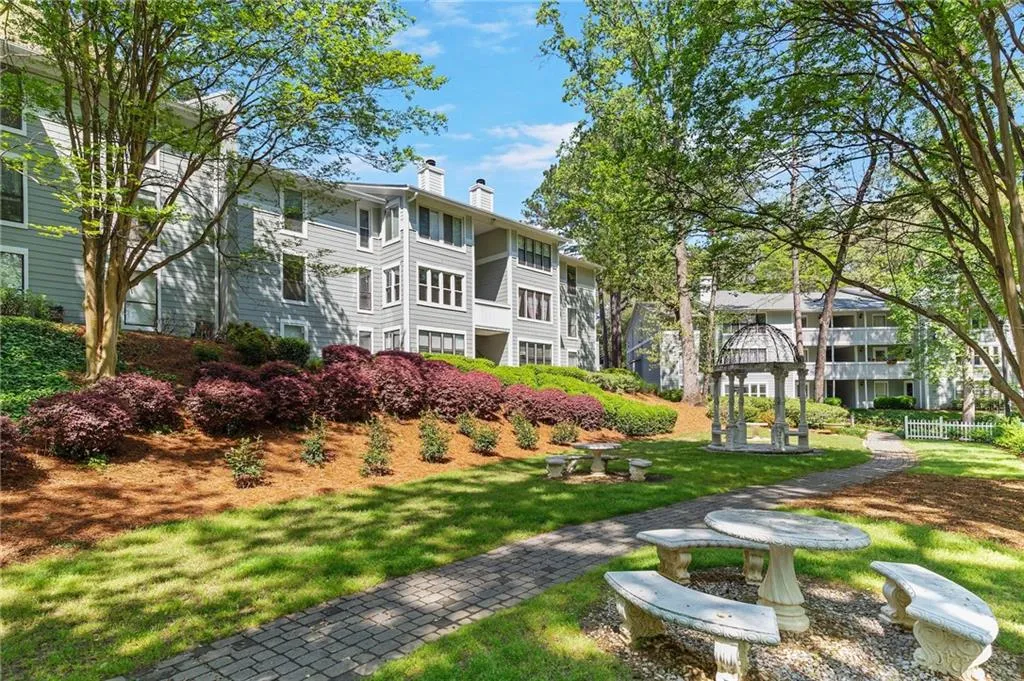 View of property's community with a lawn