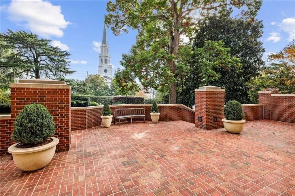 Brick paver patio with brick walls, integrated planters, and mature landscaping