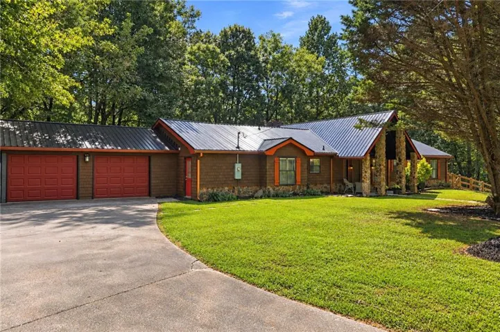 Brand New Metal Roof - August 2026! Large 2 car garage! This home is located within 5 minutes of downtown Ellijay!  Private and peaceful with all the conveniences.
