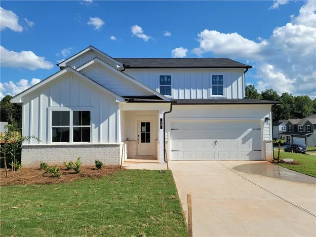 White board and batten exterior with white brick accents