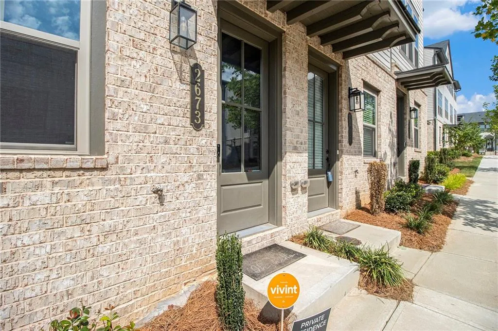 Doorway to property featuring brick siding
