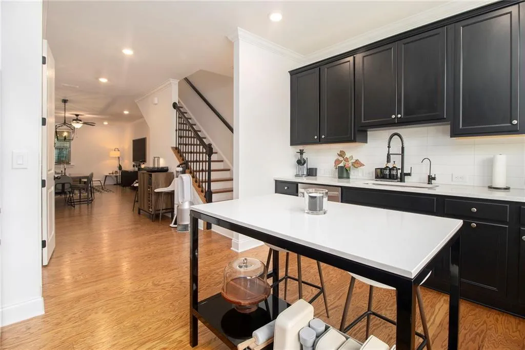 Kitchen featuring dark cabinetry, decorative backsplash, recessed lighting, ceiling fan, and light countertops