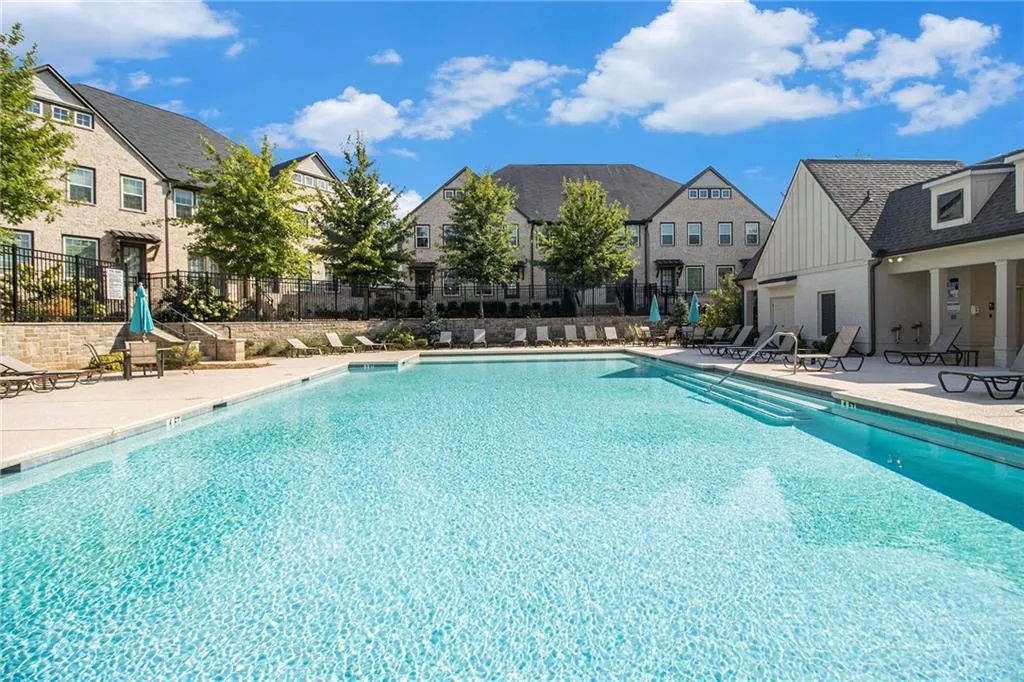 Community pool featuring a patio area and a residential view